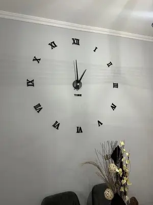 a clock on a wall with arrows on it at Casa Di Leandro in Athens