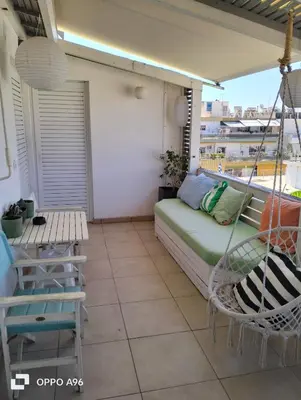 a porch with a swing and a hammock on a balcony at Minimal flat in Kalithea in Athens