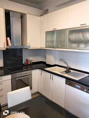 a kitchen with white cabinets and a sink at Minimal flat in Kalithea in Athens