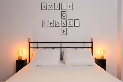 a bedroom with a bed with two white pillows at Chrysas apartment in Athens