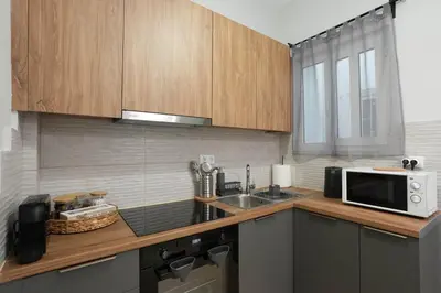 a kitchen with a sink and a microwave at Chrysas apartment in Athens
