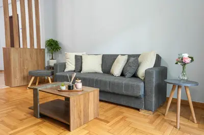 a living room with a gray couch and a table at Chrysas apartment in Athens