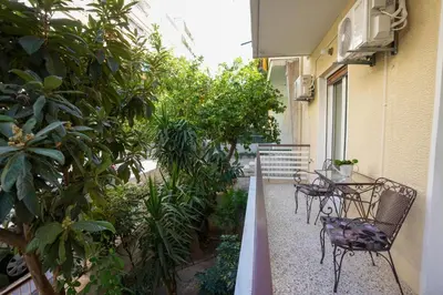 a balcony with a table and chairs and plants at Chrysas apartment in Athens