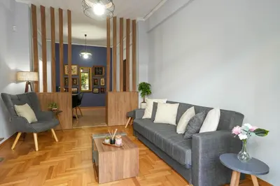 a living room with a gray couch and a table at Chrysas apartment in Athens