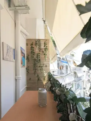 a room with a wooden table with plants on it at Central Cosy quite 28sm 5th floor balcony over garden 500m Metro Evangelismos in Athens