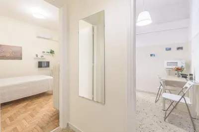 a white room with a bed and a desk at Central Cosy quite 28sm 5th floor balcony over garden 500m Metro Evangelismos in Athens