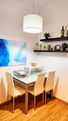 a dining room with a table with chairs and a lamp at \u4f18\u5f02\u7684\u5730\u94c1\u65c1\u516c\u5bd3 in Athens