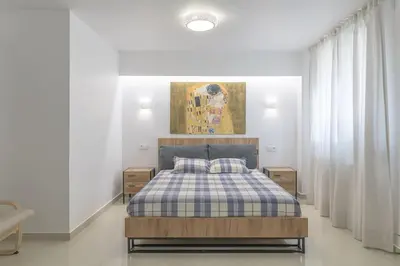 a bedroom with a bed with a checkered blanket at Golden Studio 47sm in Athens Central Pangrati 1km Metro Evangelismos in Athens