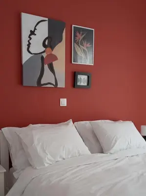 a bedroom with orange walls and a bed with white sheets at Modern 2 bedroom Apartment near Kallimarmaro and Alsos in Athens