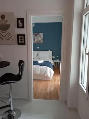 a bedroom with a bed and a chair in it at Funky & trendy 1 BDR aparment in Athens