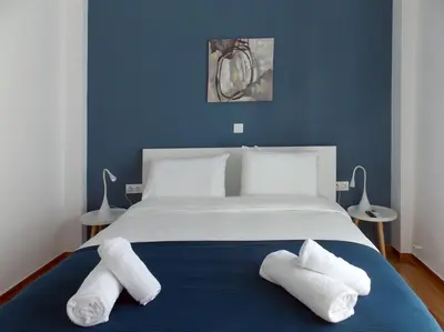 a bedroom with a bed with two towels on it at Funky & trendy 1 BDR aparment in Athens