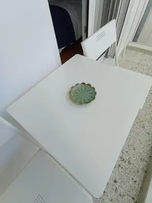 a white table with a button on top of it at Funky & trendy 1 BDR aparment in Athens