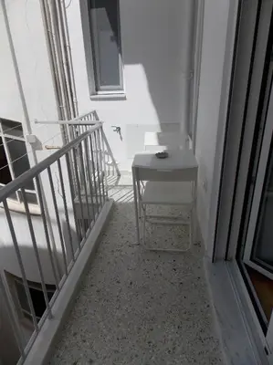 a stairway with a table and a chair in a room at Funky & trendy 1 BDR aparment in Athens
