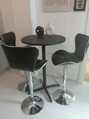 a table and two chairs and a table and a table and chairs at Funky & trendy 1 BDR aparment in Athens