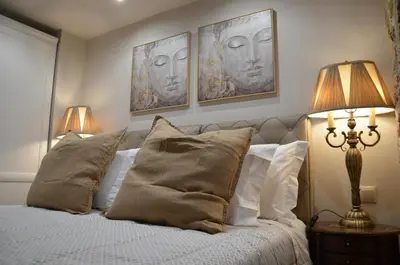 a bedroom with a bed with two heads on the wall at Air Suite in Spáta