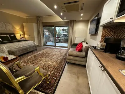 a kitchen and living room with a couch and a table at Air Suite in Spáta