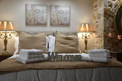 a bedroom with two lamps and a bed with pillows at Air Suite in Spáta