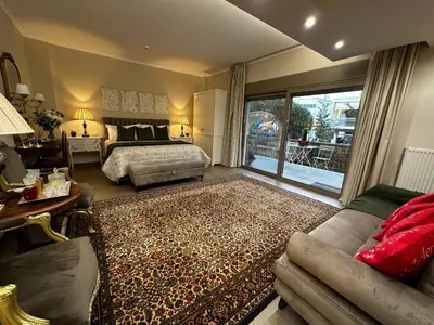 a bedroom with a bed and a living room at Air Suite in Spáta