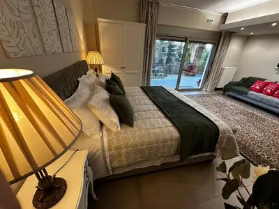 a bedroom with a large bed and a window at Air Suite in Spáta