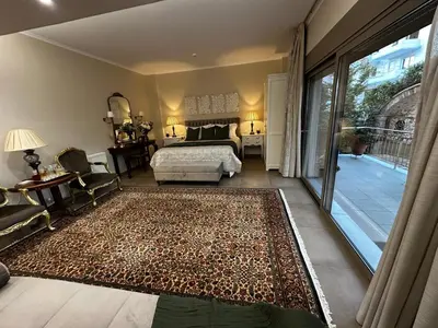 a bedroom with a bed and a large rug at Air Suite in Spáta