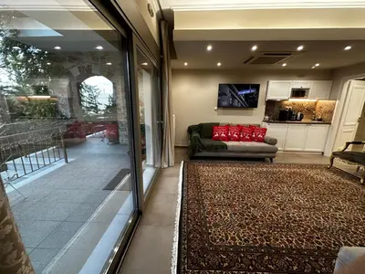 a living room with a couch and a television at Air Suite in Spáta