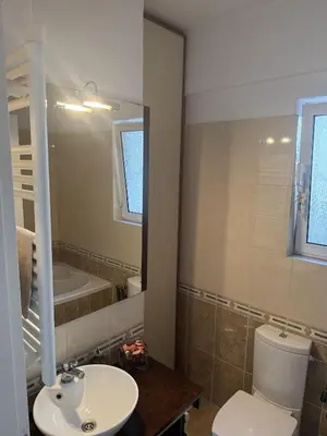 a bathroom with a sink and a toilet and a mirror at Sea View Serenity in Athens in Anavissos