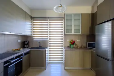 a kitchen with a sink and a refrigerator at Blue Ark Harmony Residence in Athens