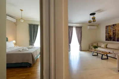 a bedroom with a bed and a couch in a room at Blue Ark Harmony Residence in Athens