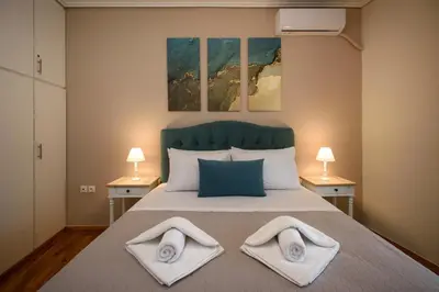 a bedroom with a bed with two towels on it at Blue Ark Harmony Residence in Athens