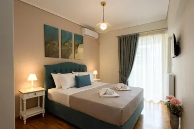 a bedroom with a bed with two towels on it at Blue Ark Harmony Residence in Athens