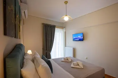 a bedroom with a bed with two slippers on it at Blue Ark Harmony Residence in Athens