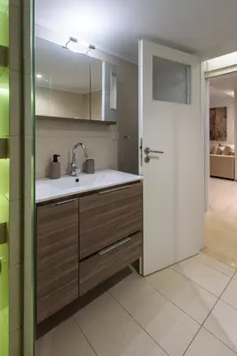 a kitchen with a sink and a door to a room at Blue Ark Harmony Residence in Athens