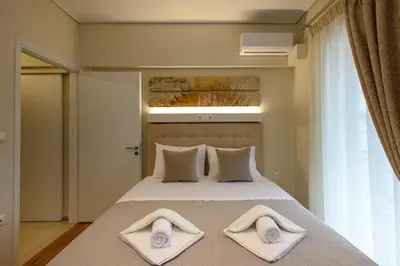 a bedroom with a bed with two towels on it at Blue Ark Harmony Residence in Athens