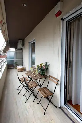 a group of chairs and a table on a balcony at Blue Ark Harmony Residence in Athens
