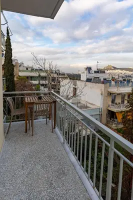 a balcony with a bench and a view of a city at Pangrati Gem views to Lycabettus in Athens