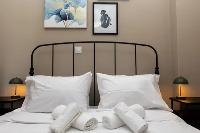 a bed with white towels on top of it at Pangrati Gem views to Lycabettus in Athens