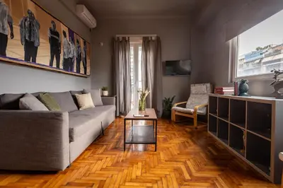a living room with a couch and a table at ERMES 2-BD Retreat with Acropolis view in Athens