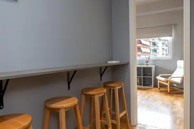 a group of stools under a counter in a room at ERMES 2-BD Retreat with Acropolis view in Athens