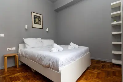 a white bed with towels on it in a room at ERMES 2-BD Retreat with Acropolis view in Athens