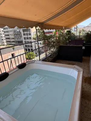 a hot tub on the roof of a building at Jacuzzi Patio & Acropolis view 2-BD Retreat in Athens