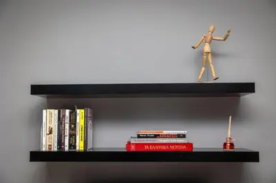 a toy man standing on a shelf with books at Jacuzzi Patio & Acropolis view 2-BD Retreat in Athens