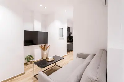 a white living room with a couch and a table at Alma Suite - close to Acropolis in Athens
