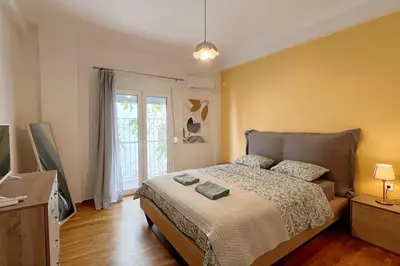a bedroom with a bed and a television in it at National Park in Athens