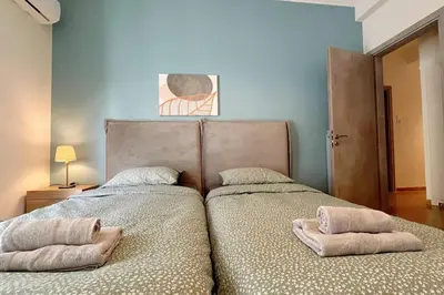 two beds sitting next to each other in a bedroom at National Park in Athens