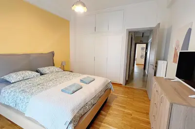 a bedroom with a bed and a flat screen tv at National Park in Athens