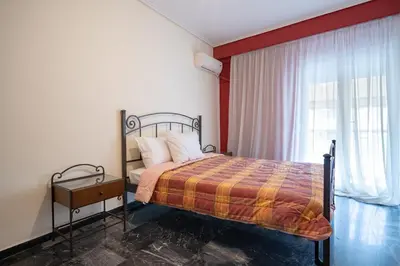 a bedroom with a bed and a window at Mesogion 3 person apartment by MPS in Athens