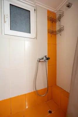 a shower in a bathroom with a window at Mesogion 3 person apartment by MPS in Athens