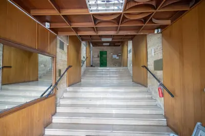 a staircase in a building with a green door at Mesogion 3 person apartment by MPS in Athens