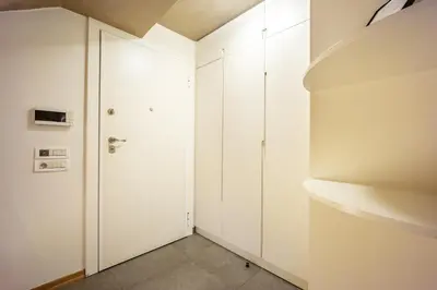 a room with white cabinets and a door at Alia by GK Properties in Athens