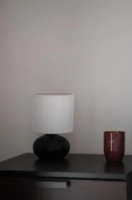a lamp sitting on top of a desk with a candle at Urban Chic Hideaway Near Athens Center & Metro in Athens